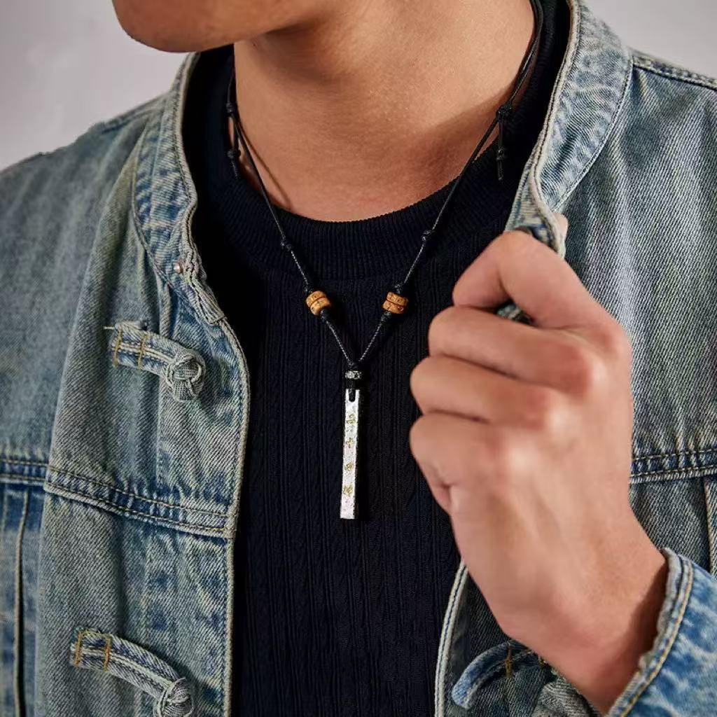 Tian Peng Chi Pendant – man wearing black cord ruler necklace with denim jacket, lifestyle shot, spiritual authority protection amulet