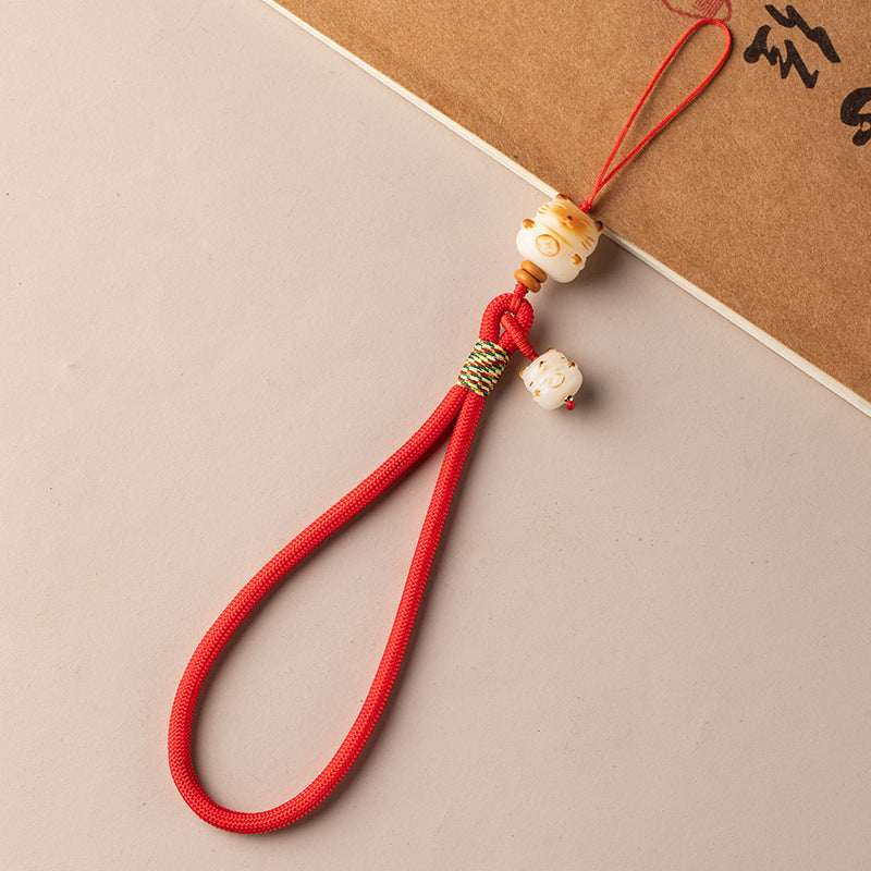 Bodhi Maneki Neko phone strap in bright red cord with fortune cat bead pendant