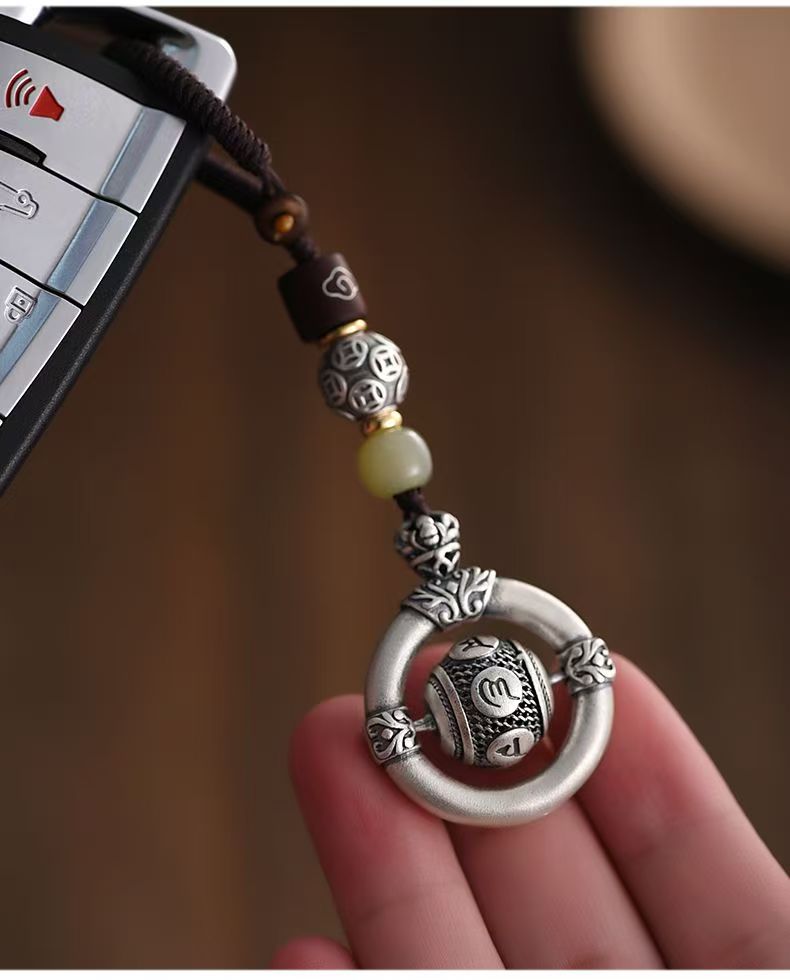 Mantra Keychain – antique silver charm attached to car key fob, hand holding protection accessory