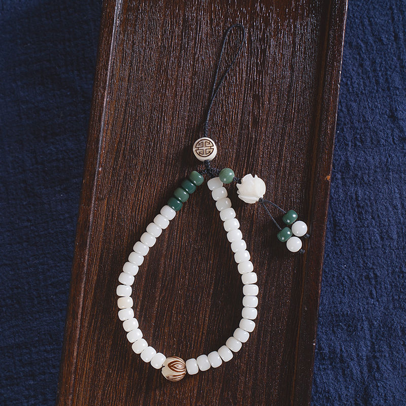 White Jade Bodhi & Jadeite Crystal Phone Charm – White bodhi beads with green jadeite, copper flower, and carved lotus seed detail on wood