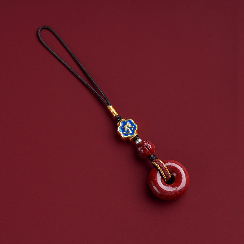 Natural cinnabar zodiac amulet with blue enamel zodiac charm flat lay product photo