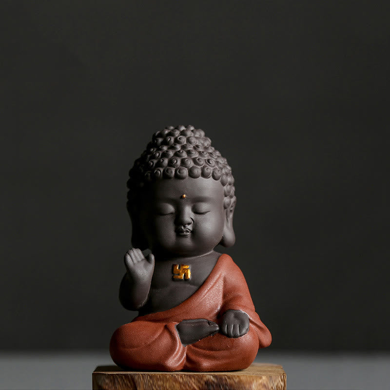 Small Buddha Purple Clay Decoration – single orange-robe figure on wood base, three-quarter view, gold swastika chest mark,禅定
