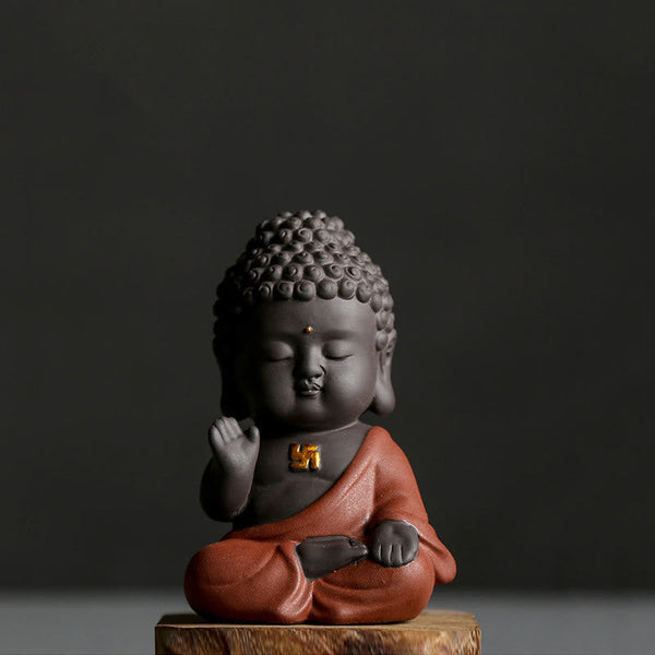 Small Buddha Purple Clay Decoration – single orange-robe figure on wood base, three-quarter view, gold swastika chest mark,禅定