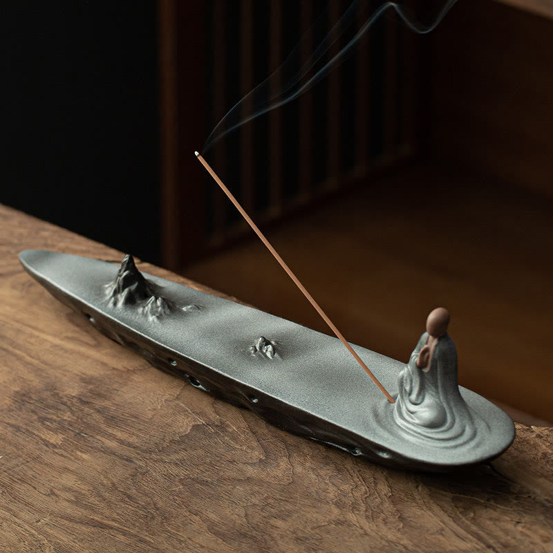 Buddha Monk Sea Wave Mountain Ceramic Incense Burner – Matte gray monk on mountain landscape base with rising smoke, zen incense burner