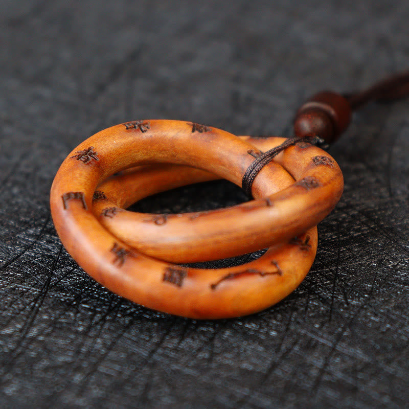 Qiankun Circle Necklace – Carved interlocking qiankun circle pendant with burned auspicious Chinese characters, honey-amber p
