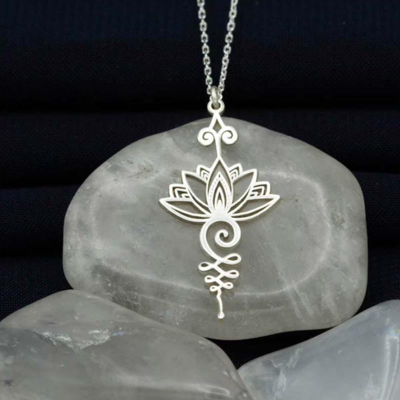 Lotus Luck Wealth Titanium Necklace – silver lotus unalome pendant on cable chain over gray stone, spiritual