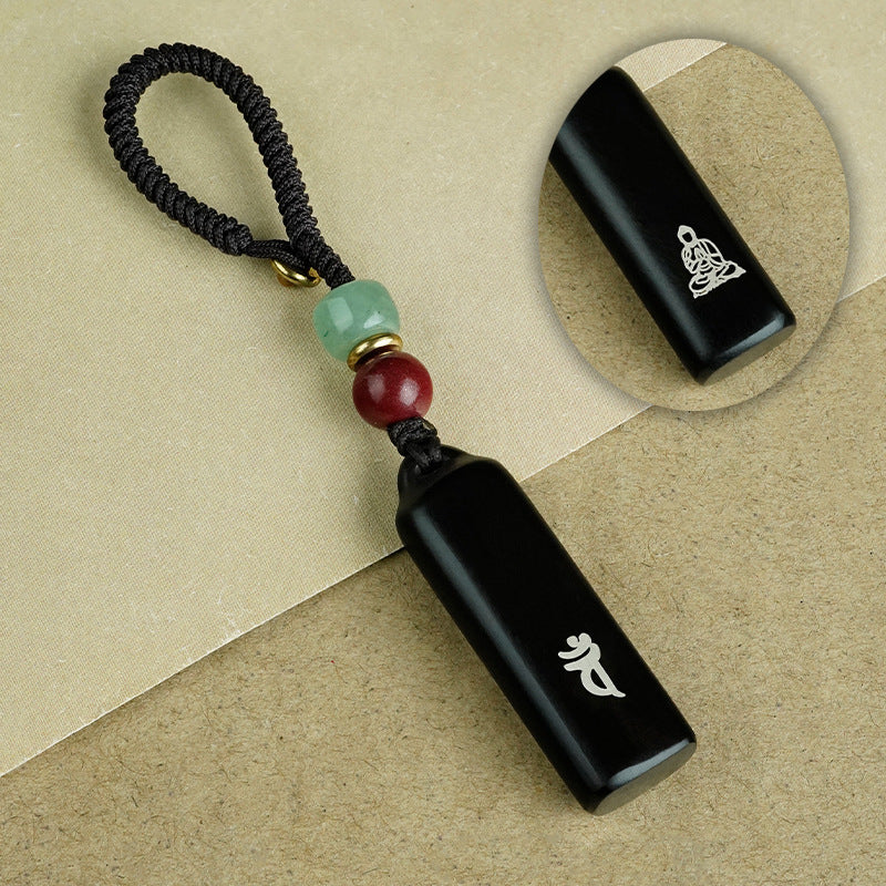 Ebony Eight Guardians talisman keychain attached to smartphone showing real world scale and usage