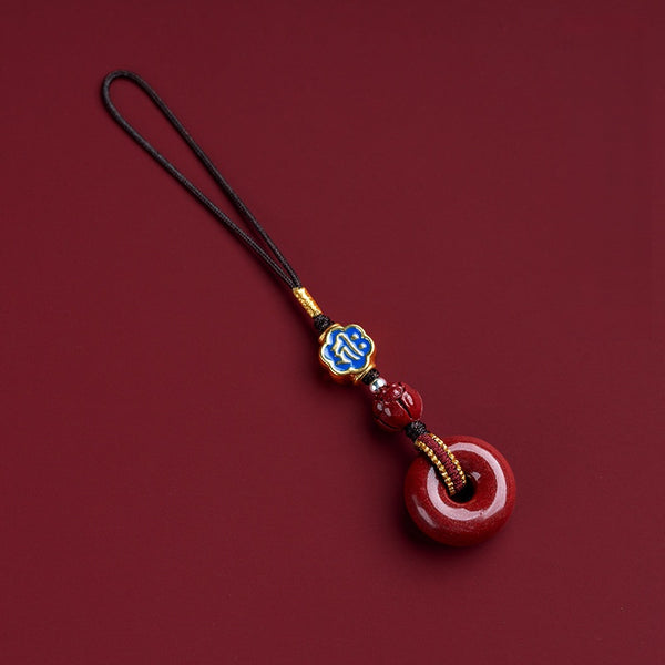 Natural cinnabar zodiac amulet with blue enamel zodiac charm side angle shot