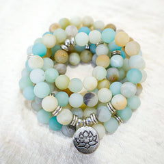 Amazonite Lotus Mala – wrap bracelet with silver spacers on plush white surface, amazonite beads