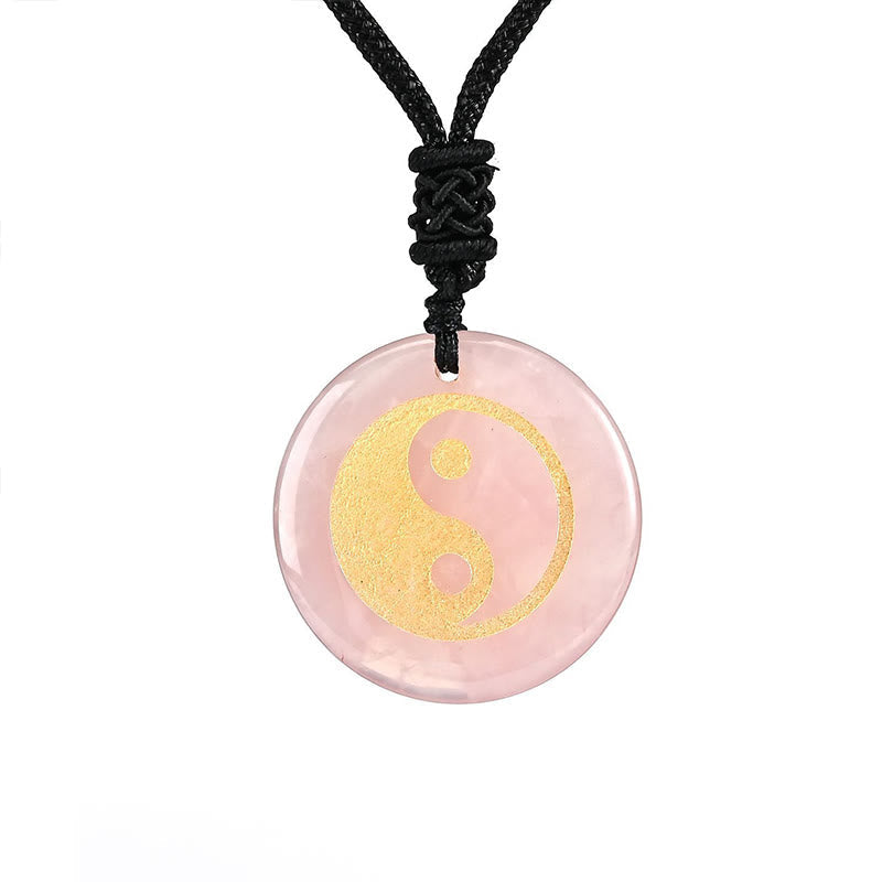Yin Yang Crystal Necklace – Rose quartz pendant with gold yin-yang symbol on black cord, semi-precious pink stone jewelry wit