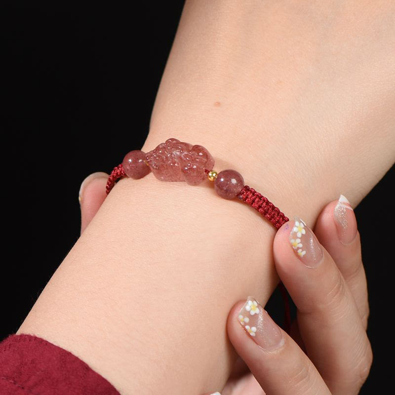 Strawberry Quartz PiXiu Red Bracelet – model wrist floral nail art black background, love luck red string
