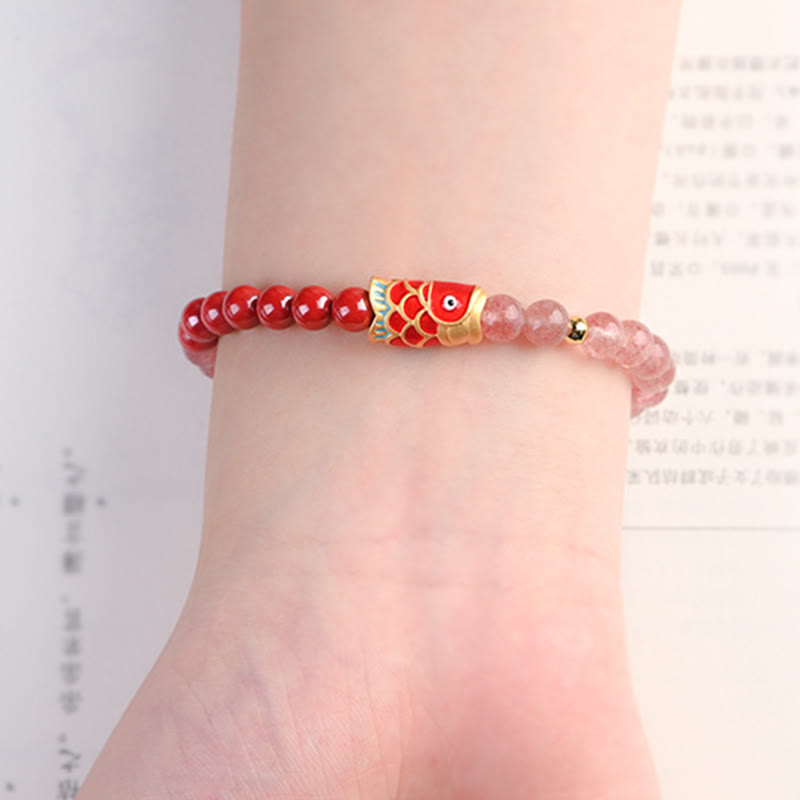 Strawberry Quartz Koi Bracelet – flat lay with dried flowers and healing crystal props