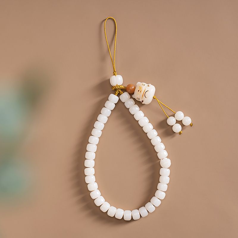 White Jade Bodhi & Jadeite Crystal Phone Charm – White bodhi beads with gold cord, carved cat charm, and small bead tassels