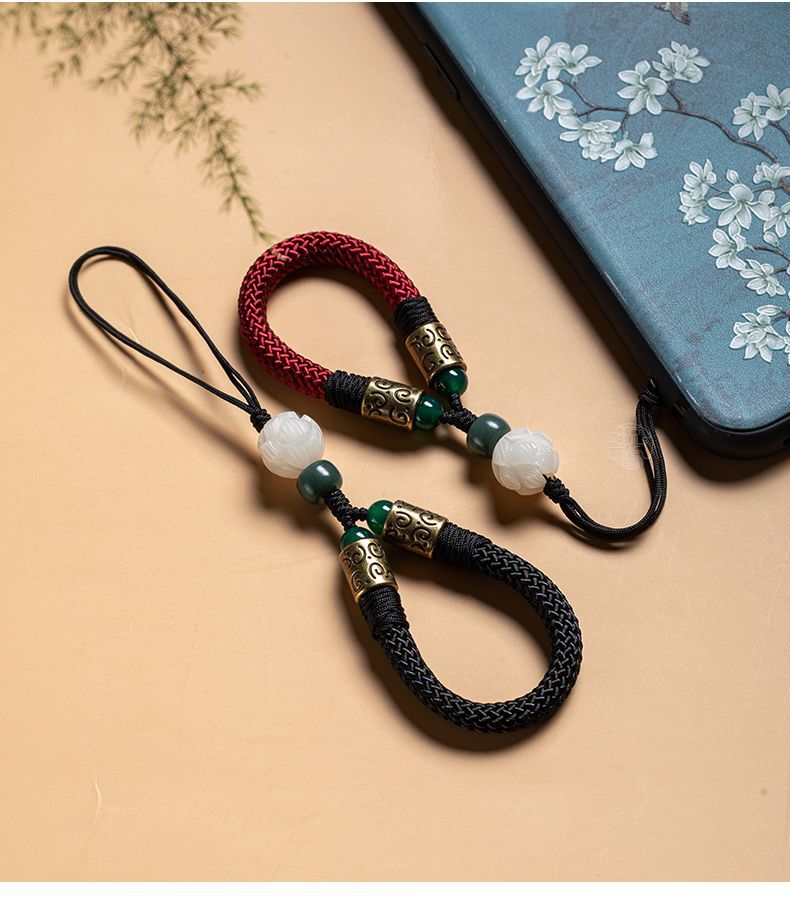 Lotus Bodhi Lanyard – Red and black straps on ornate blue phone case with white blossoms, dual color phone lanyard display