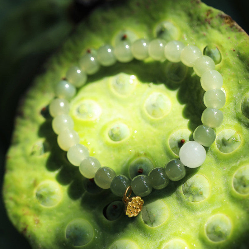 Jade Lotus Abundance Bracelet – Green to white gradient jade beads with gold lotus pod on lotus pod, abundance