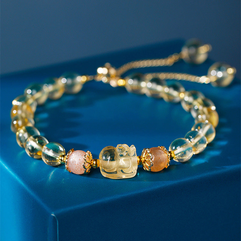 Citrine PiXiu Bracelet – golden citrine beads pink accents blue background, wealth crystal
