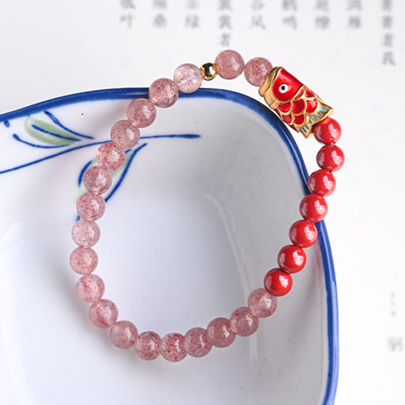 Strawberry Quartz Koi Bracelet – macro shot of koi fish carving on cinnabar showing artistic craftsmanship