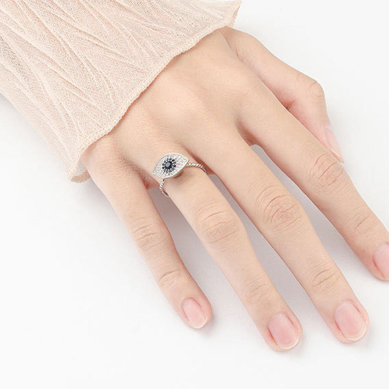 Evil Eye Rotatable Ring – Silver rotating evil eye ring with blue center, pave stones, rope band
