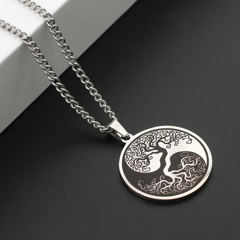 Tree of Life Titanium Steel Necklace – silver pendant on dark surface with white block, angled view, connection pendant