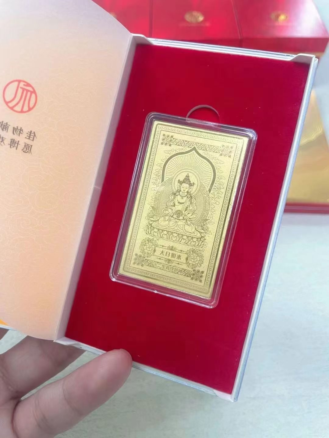 Guardian Gods Gold Foil Phone Sticker – Mahavairocana gold foil card presented in open red velvet gift box with branded sleeve, premium packaging shot