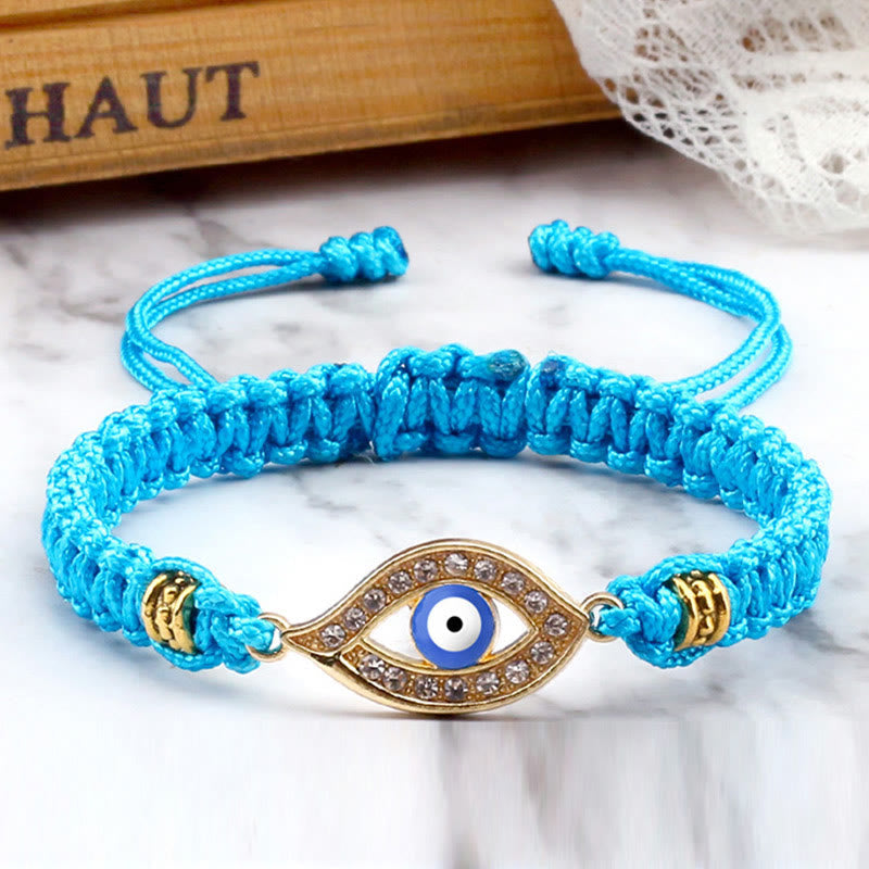 Turquoise cord evil eye bracelet with gold evil eye crystal charm, marble lifestyle
