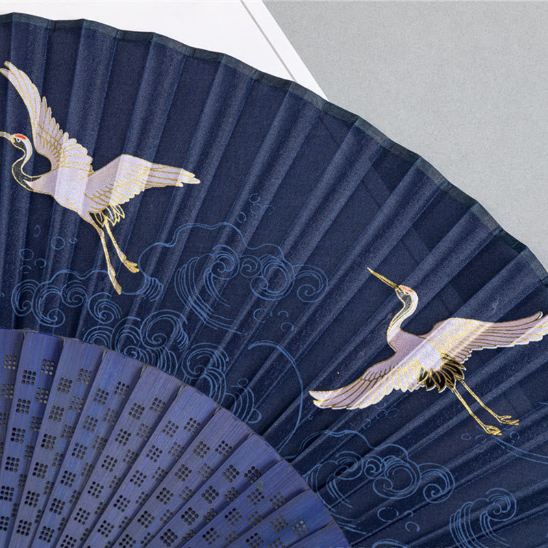 Crane Folding Fan Detail – Two gold-accented cranes and wave motifs on navy silk, hand fan