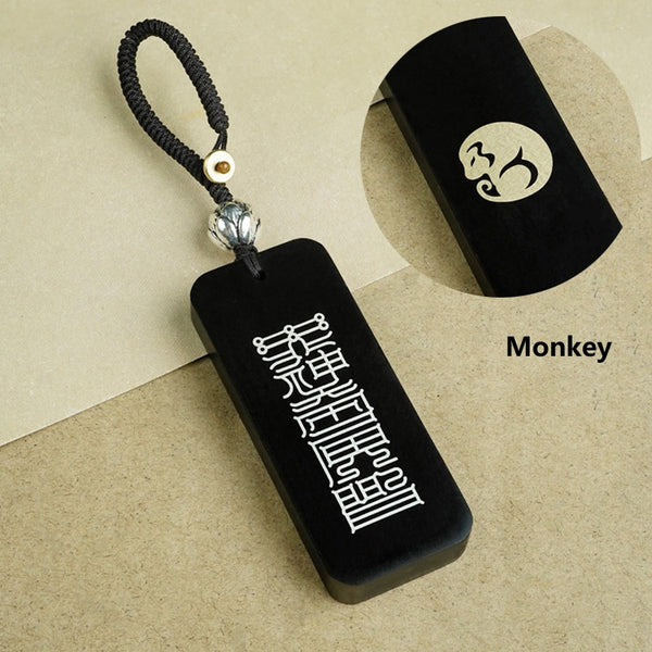 Ebony zodiac keychain material detail showing copper inlay versus silver inlay and dimensions 25x60x8mm