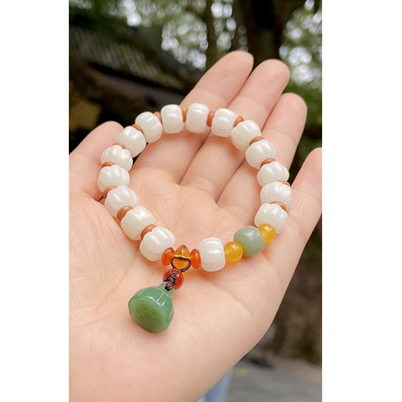 Bodhi Seed Lotus Bead Bracelet - resting on palm, natural garden setting peaceful