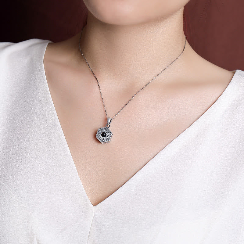 Lotus Projection Necklace – Worn on model showing pendant against chest, sterling silver spiritual jewelry