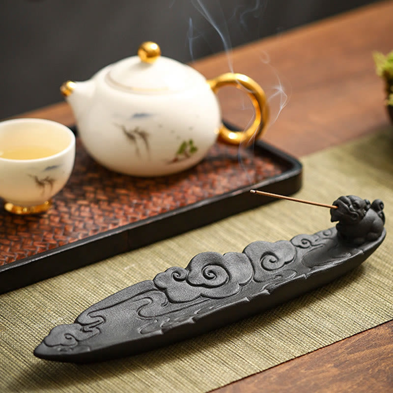 Pixiu incense burner with smoke, white porcelain teapot with bird painting and gold accents, rattan tray – ceramic incense holder set