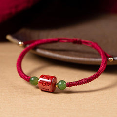 Tibetan Cinnabar Braided Rope Bracelet – Three-quarter view showing carved cinnabar bead and braided cord detail