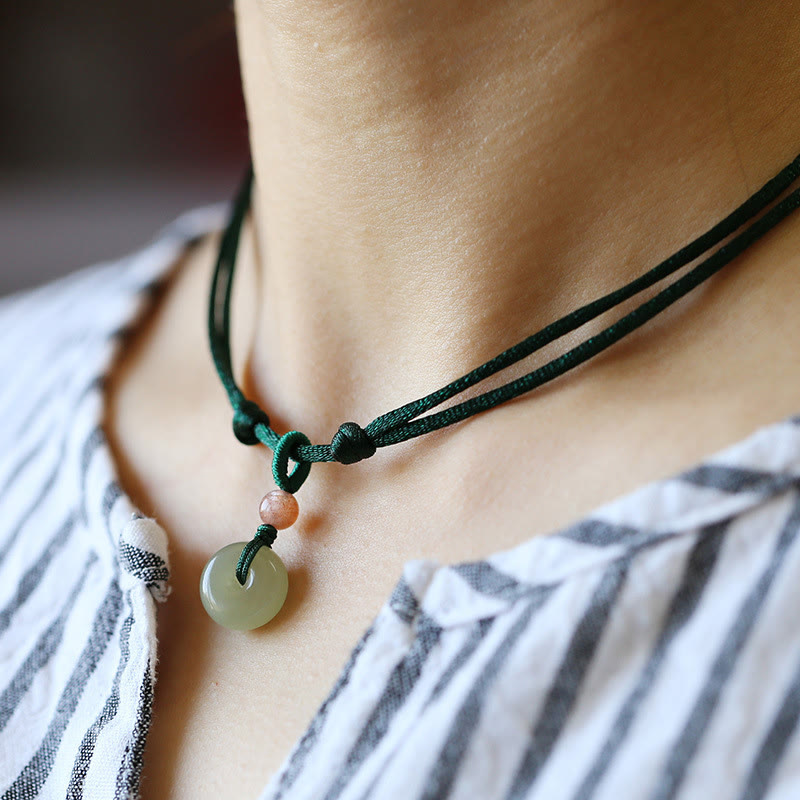 Jade Peace Buckle Lotus Necklace – Green jade donut pendant worn on neck with sliding knot cord, jade choker
