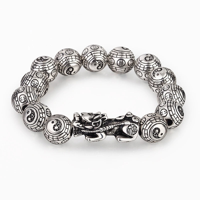 Tibetan Feng Shui PiXiu Silver Bracelet – Top-down view of oxidized silver Pixiu centerpiece with twelve Tai Chi Bagua beads in symmetrical layout