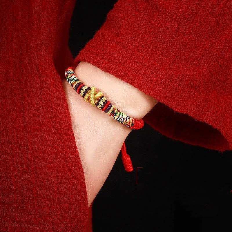 Tibetan Mantra Bracelet – Side view on wrist with gold accent and multicolor woven pattern, styled jewelry