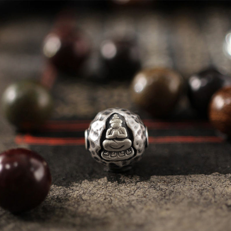 999 Sterling Silver Sandalwood Buddha Bracelet – Macro of textured silver Buddha bead with hammered finish, spiritual craftsmanship