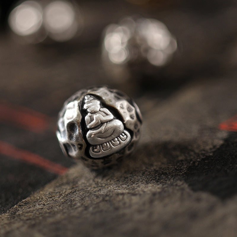 999 Sterling Silver Sandalwood Buddha Bracelet – Extreme close-up of silver Buddha bead hammered texture, artisan detail