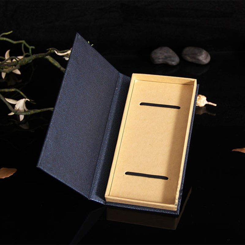 Tree of Life Wood Bookmarks - open navy brocade gift box with elastic bands on black background, zen props