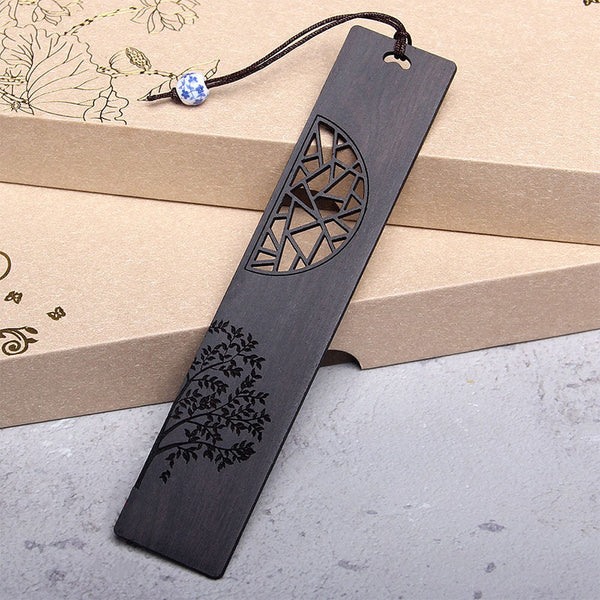 Tree of Life Wood Bookmarks - single ebony bookmark with lattice cutout leaning on kraft boxes, porcelain bead