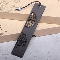 Tree of Life Wood Bookmarks - single ebony bookmark with lattice cutout leaning on kraft boxes, porcelain bead