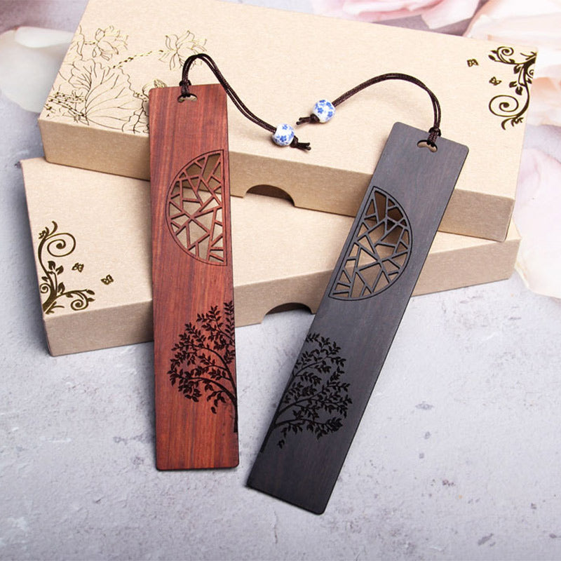 Tree of Life Wood Bookmarks - pair of bookmarks with porcelain beads leaning on kraft boxes, gold patterns