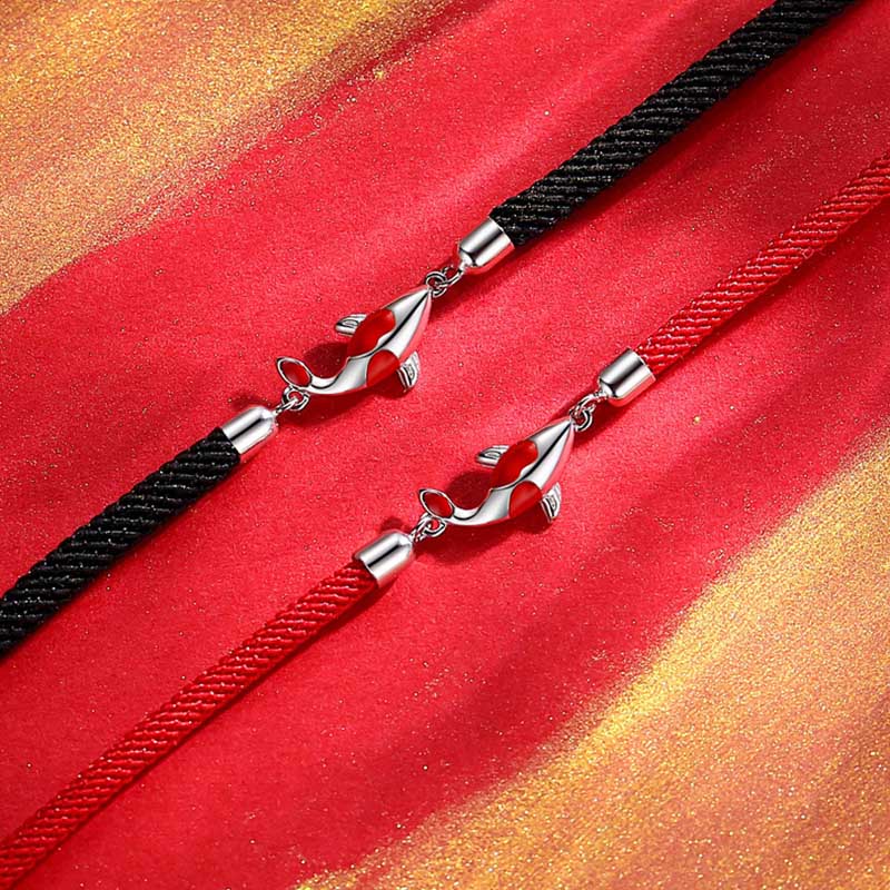 Koi Fish Braided Bracelet - Top-down view of fish pendant on red cord, protection jewelry
