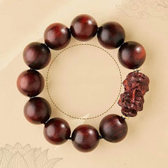 Red Sandalwood PiXiu Bracelet – Bracelet on beige background with dashed circle and lotus outline, meditation