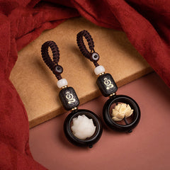 Ebony Wood Bodhi Seed Lotus Key Chain - two lotus color variants on burgundy fabric