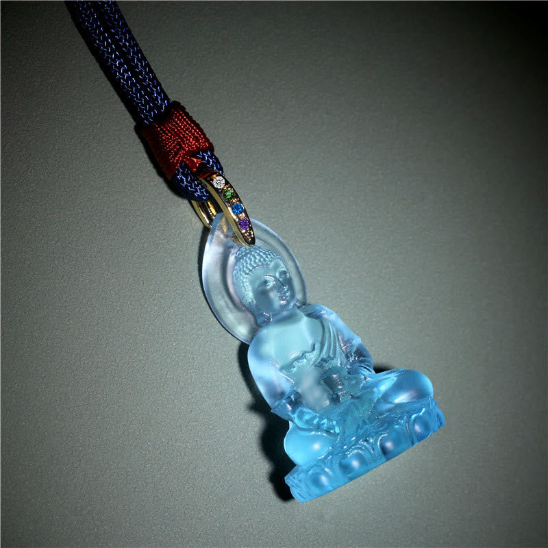 Blue Tathagata Medicine Buddha Liuli Crystal Necklace – carved crystal Buddha in dhyana mudra, translucent aqua material, gray studio background, serene detail shot