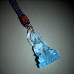 Blue Tathagata Medicine Buddha Liuli Crystal Necklace – carved crystal Buddha in dhyana mudra, translucent aqua material, gray studio background, serene detail shot