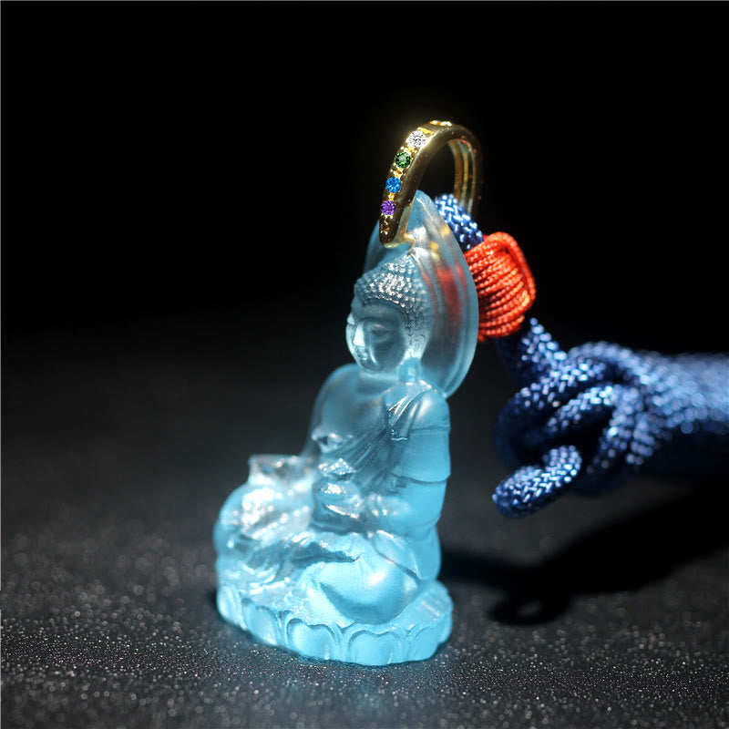 Blue Tathagata Medicine Buddha Liuli Crystal Necklace – frosted blue liuli Buddha on lotus base with halo, gold gemstone bail and red Chinese knot cord accent