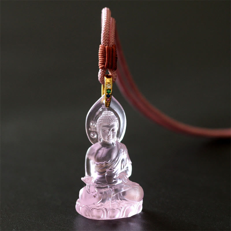 Blue Tathagata Medicine Buddha Liuli Crystal Necklace – translucent rose quartz Buddha with pinkish-red cord and green stone bail, dark charcoal minimalist product shot