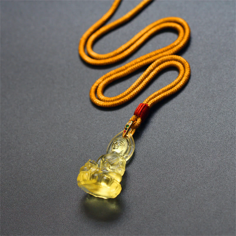 Blue Tathagata Medicine Buddha Liuli Crystal Necklace – close-up of amber Buddha with mustard cord and red wrap, shallow depth of field, dark neutral background