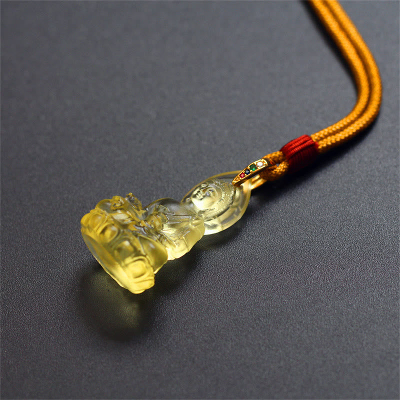 Blue Tathagata Medicine Buddha Liuli Crystal Necklace – yellow crystal Buddha pendant with golden-orange rope cord, red knot section, gold-toned connector, soft lighting