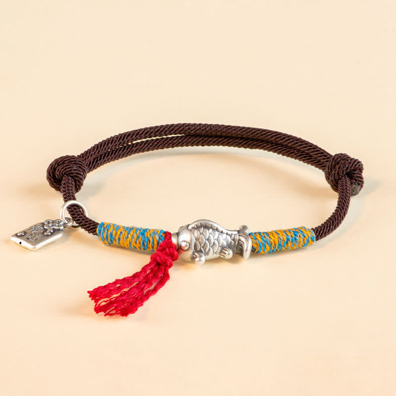Silver Koi Bracelet – Flat lay with protective amulet and blessing card